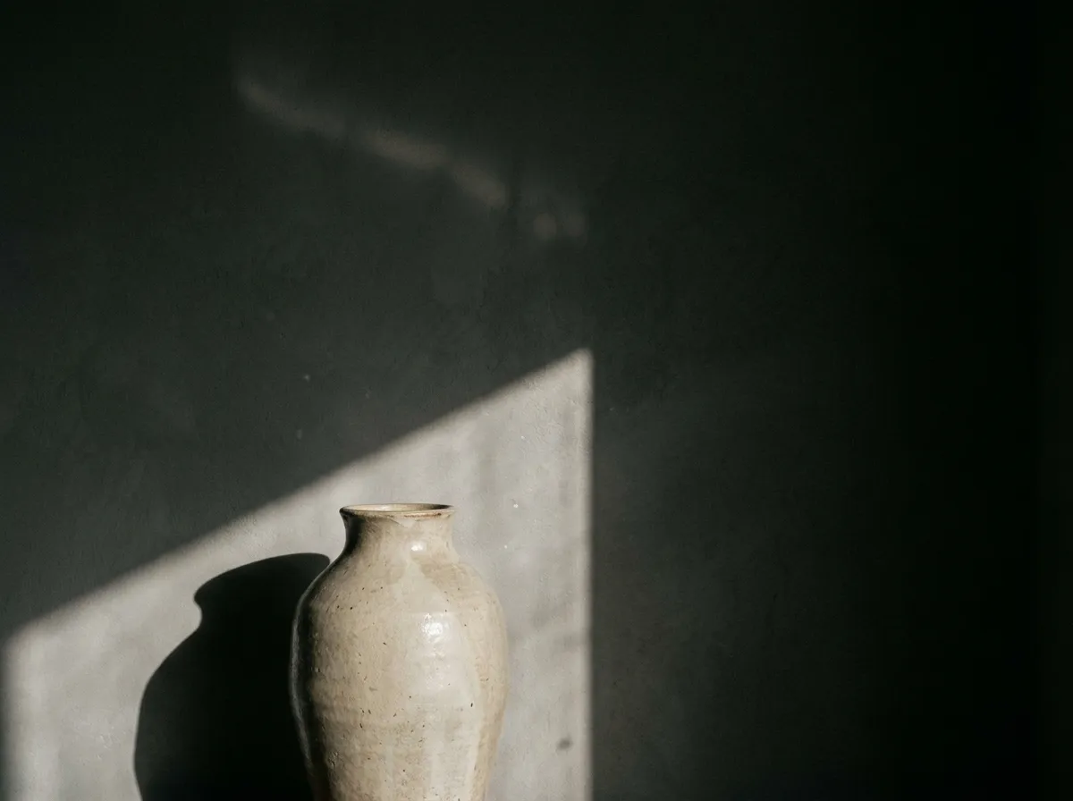 A ceramic object catching a shaft of window light